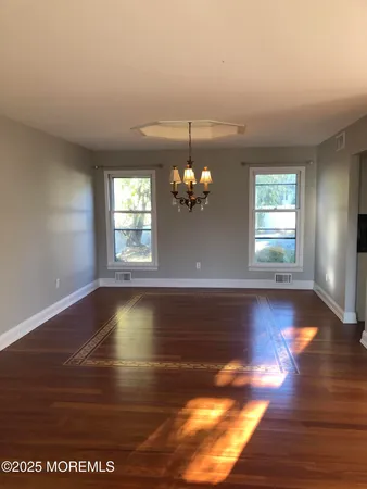 a view of a room with window and wooden floor