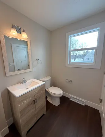 a bathroom with a toilet sink and mirror