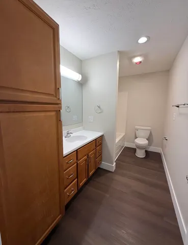 a bathroom with a double vanity sink and a toilet