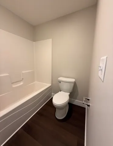 a bathroom with a toilet and a bathtub