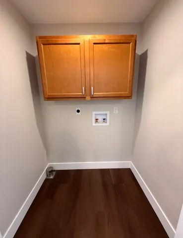 a view of room with wooden floor and a window