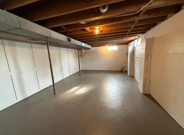 a view of empty room with wooden walls
