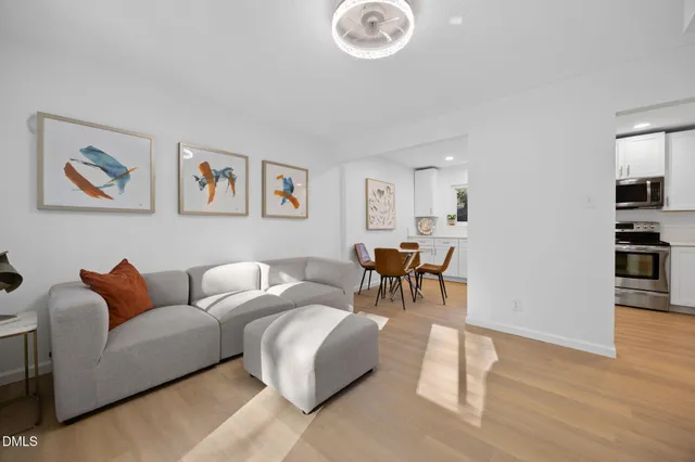 a kitchen with white cabinets and appliances
