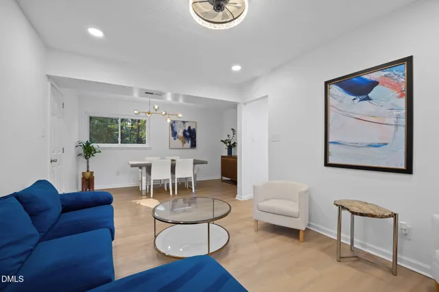 a dining room with furniture and a window