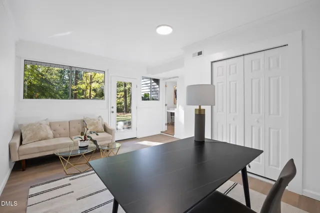 a living room with furniture and a wooden floor