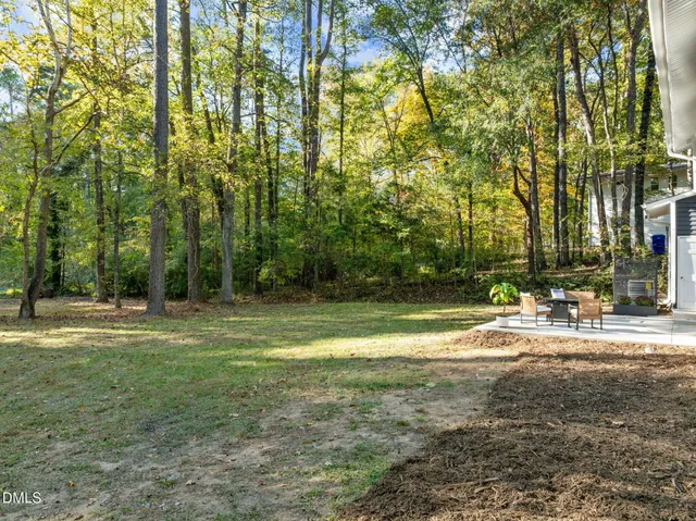 a bedroom with a bed and painting on the wall