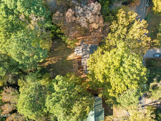 a view of a yard with large trees