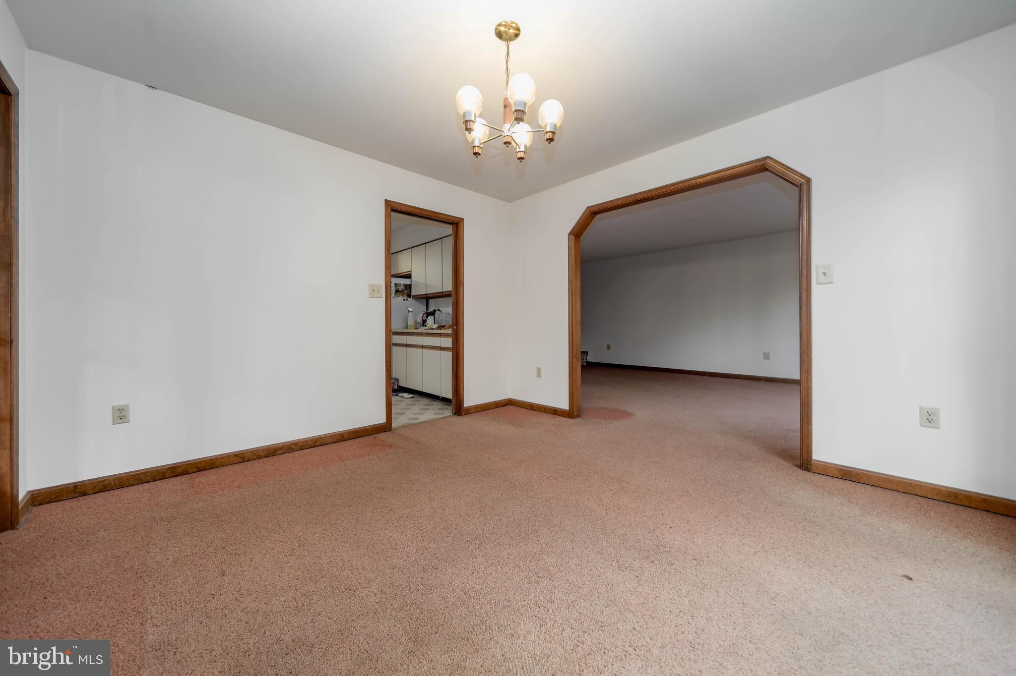 5510 Stephen Reid Road Huntingtown, MD 20639 - Photo 14 of 59 a view of a big room with windows and chandelier