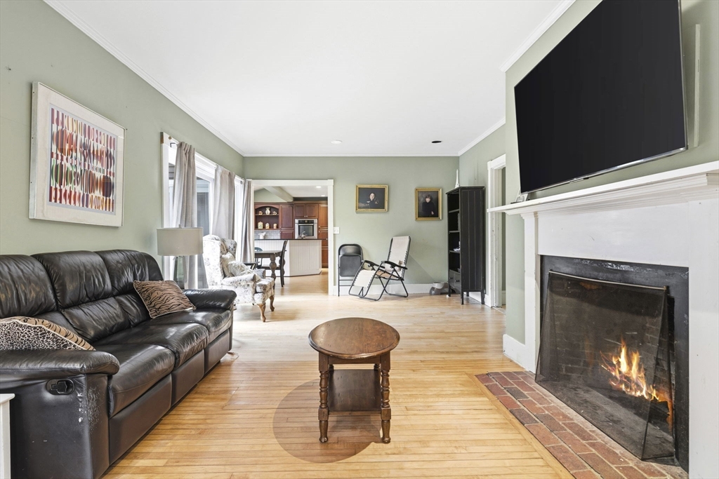 17 Wellesley Street Weston, MA 02493 - Photo 9 of 30 a living room with furniture a flat screen tv and a fireplace