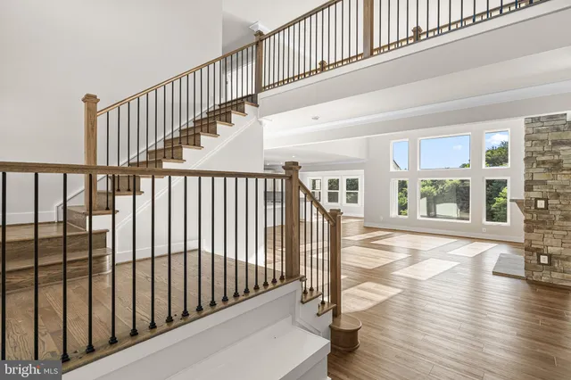 a view of staircase with lots of wooden floor and a rug
