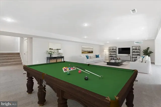 a room with pool table and windows