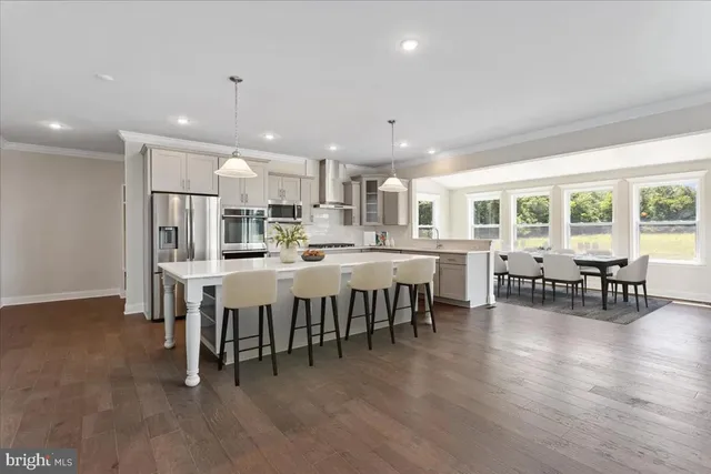 a large kitchen with a table and chairs