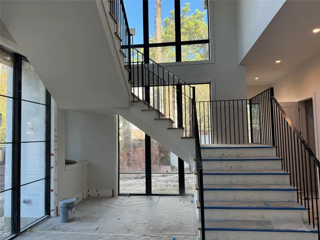 a kitchen with white cabinets and a wooden floor