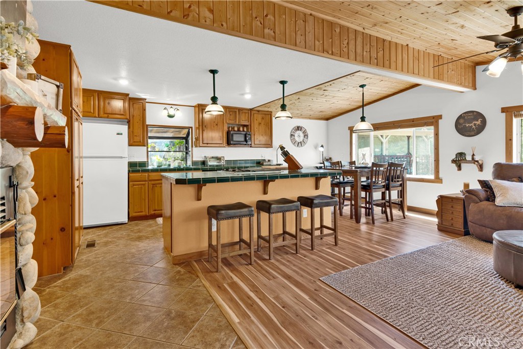 4653 Green Pine Lane Paso Robles, CA 93446 - Photo 36 of 36 a dining hall with stainless steel appliances kitchen island granite countertop a table and chairs in it