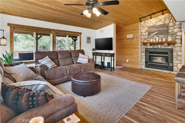 a living room with furniture a chandelier and a large window