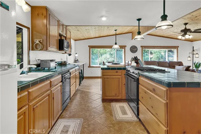 a kitchen with stainless steel appliances granite countertop a sink and a stove