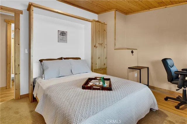 a bedroom with a bed and a chair