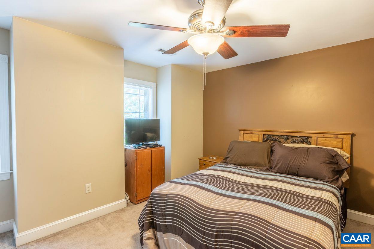 6444 Spring Hill Road Ruckersville, VA 22968 - Photo 16 of 31 a bedroom with a bed and a chandelier
