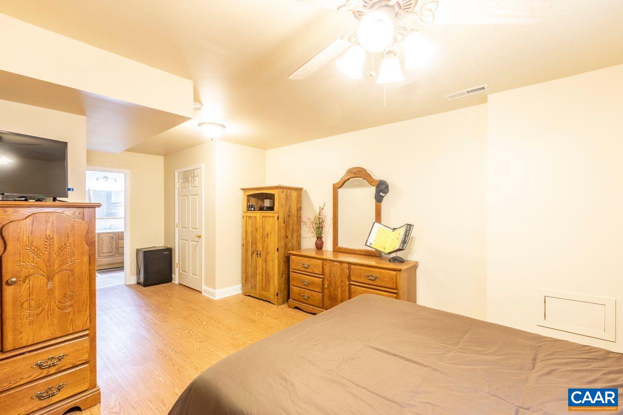 6444 Spring Hill Road Ruckersville, VA 22968 - Photo 18 of 31 a bedroom with a bed and a flat screen tv