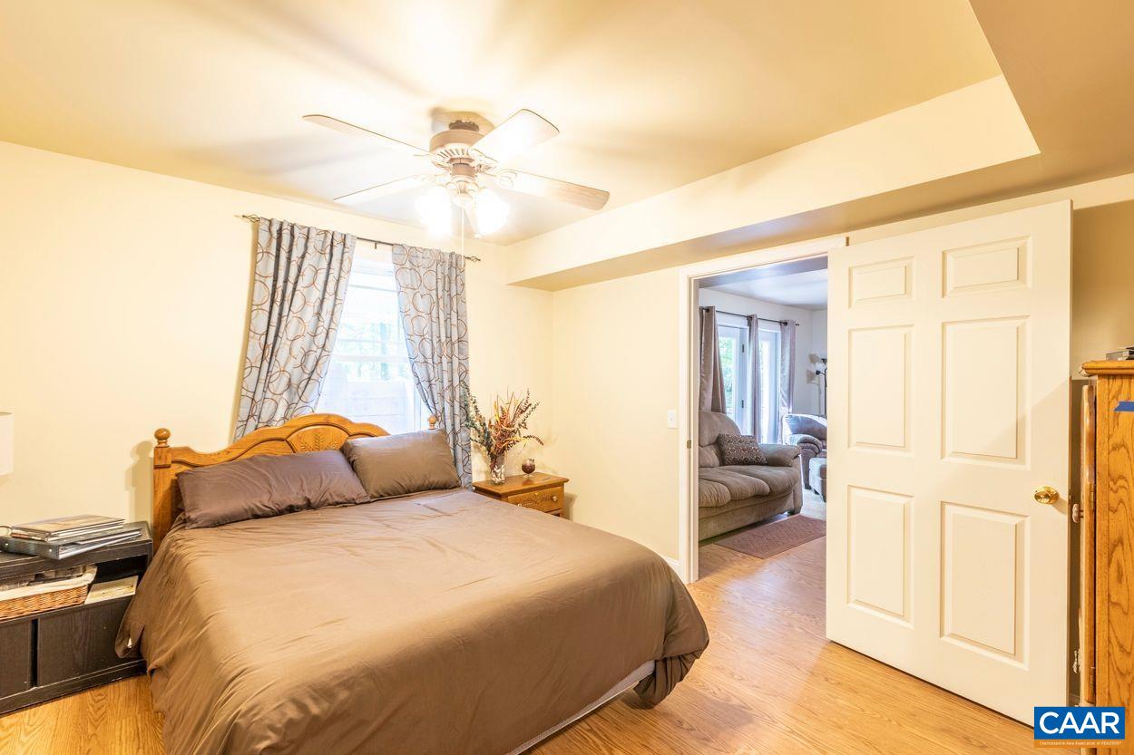 6444 Spring Hill Road Ruckersville, VA 22968 - Photo 19 of 31 a bedroom with a bed and wooden floor