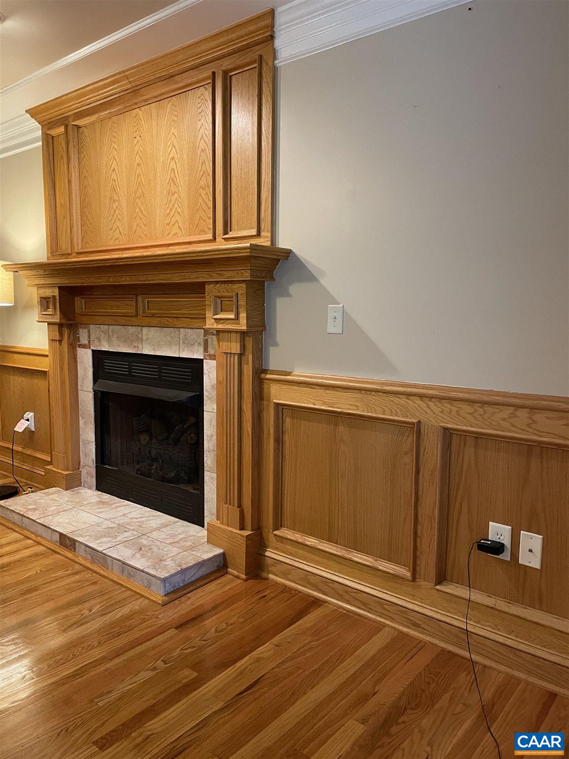 6444 Spring Hill Road Ruckersville, VA 22968 - Photo 30 of 31 a view of an empty room with wooden floor and a fireplace