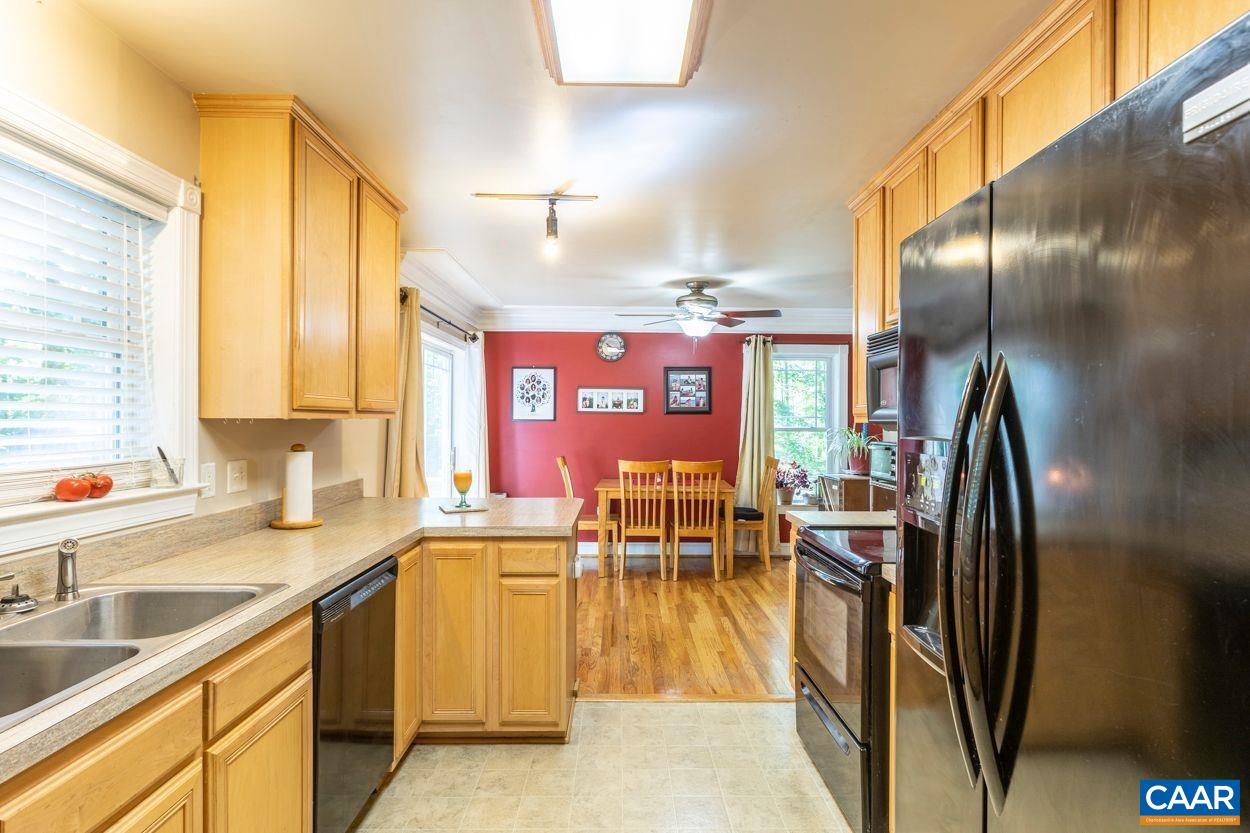 6444 Spring Hill Road Ruckersville, VA 22968 - Photo 3 of 31 a kitchen with stainless steel appliances granite countertop a sink a stove and a refrigerator