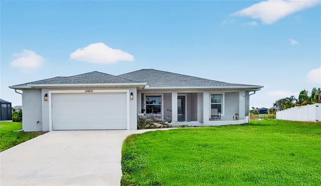 a front view of a house with garden and patio