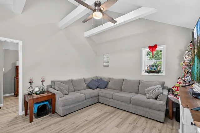 a view of a kitchen area with furniture and wooden floor