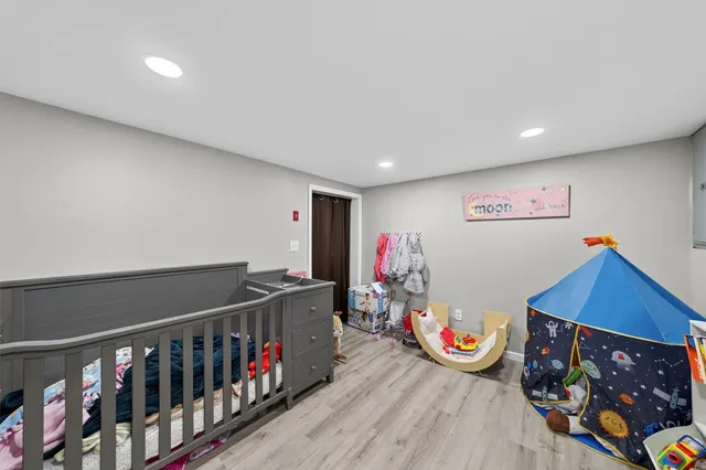 a bathroom with a toilet a sink a mirror a vanity and window