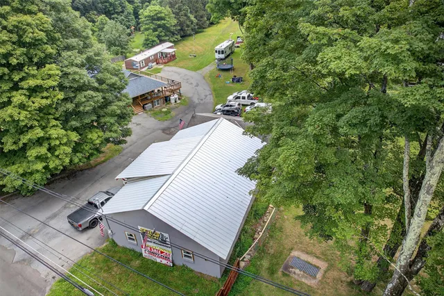 an aerial view of a house with a yard and garden