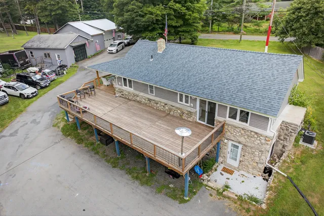 a kitchen view with stainless steel appliances wooden floor and dining table