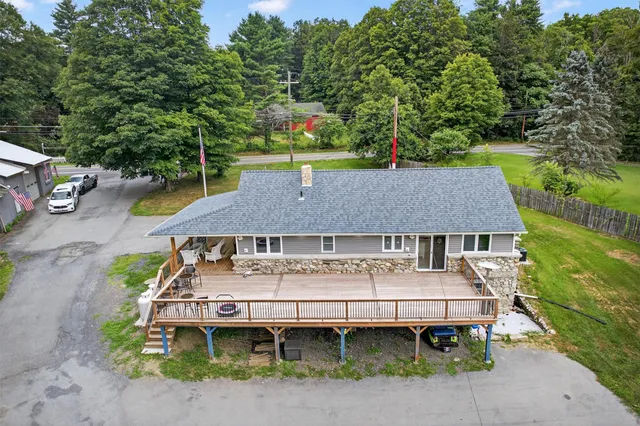an aerial view of a house with a yard table and chairs