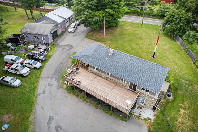 an aerial view of a house with a yard