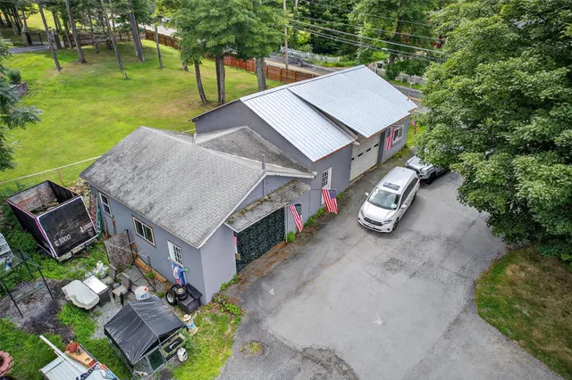 an aerial view of a house with a yard table and chairs