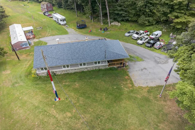 an aerial view of a house with garden space pool seating area and yard