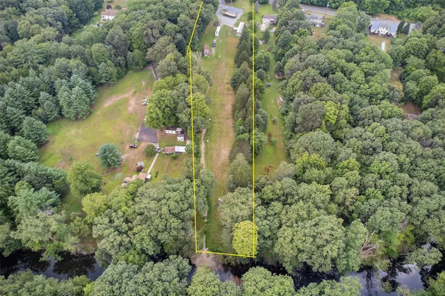 a aerial view of a house with swimming pool garden and patio