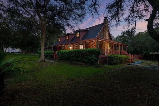 a front view of house with a garden