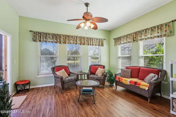 a view of a dining room with furniture window and wooden floor