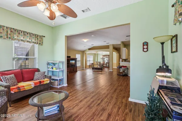a dining room with furniture window and wooden floor