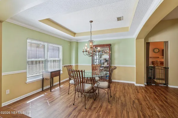 a view of a kitchen with furniture and wooden floor