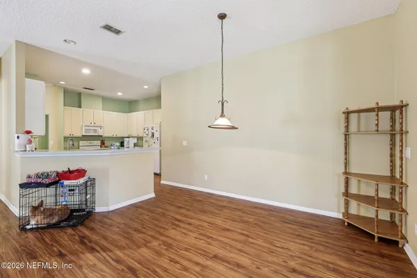 a kitchen with a white cabinets and white appliances