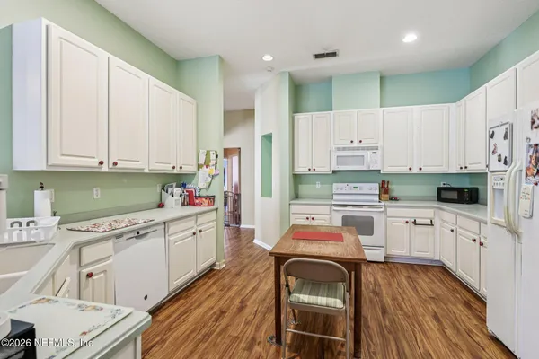 a kitchen with stainless steel appliances a stove a sink dishwasher and a refrigerator