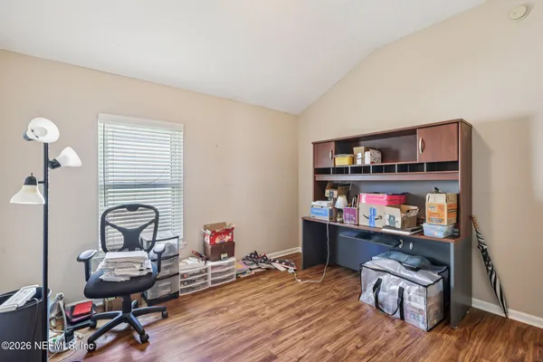 a room with furniture a rug and white walls