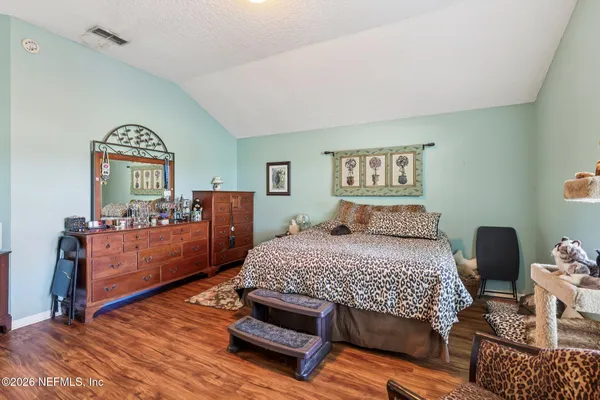 a bedroom with a bed and a dresser