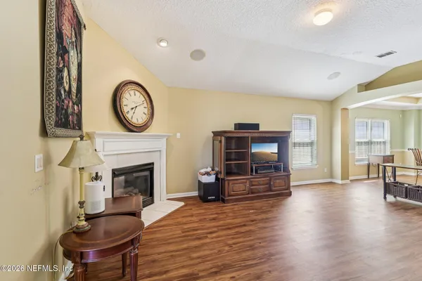 a living room with furniture a fireplace and a flat screen tv