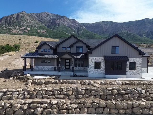 583 East Mountain Road, Unit 179 Ogden, UT 84414 - Photo 1 of 1 Contemporary architecture featuring a multi-gabled roofline and a stone and board and batten facade
