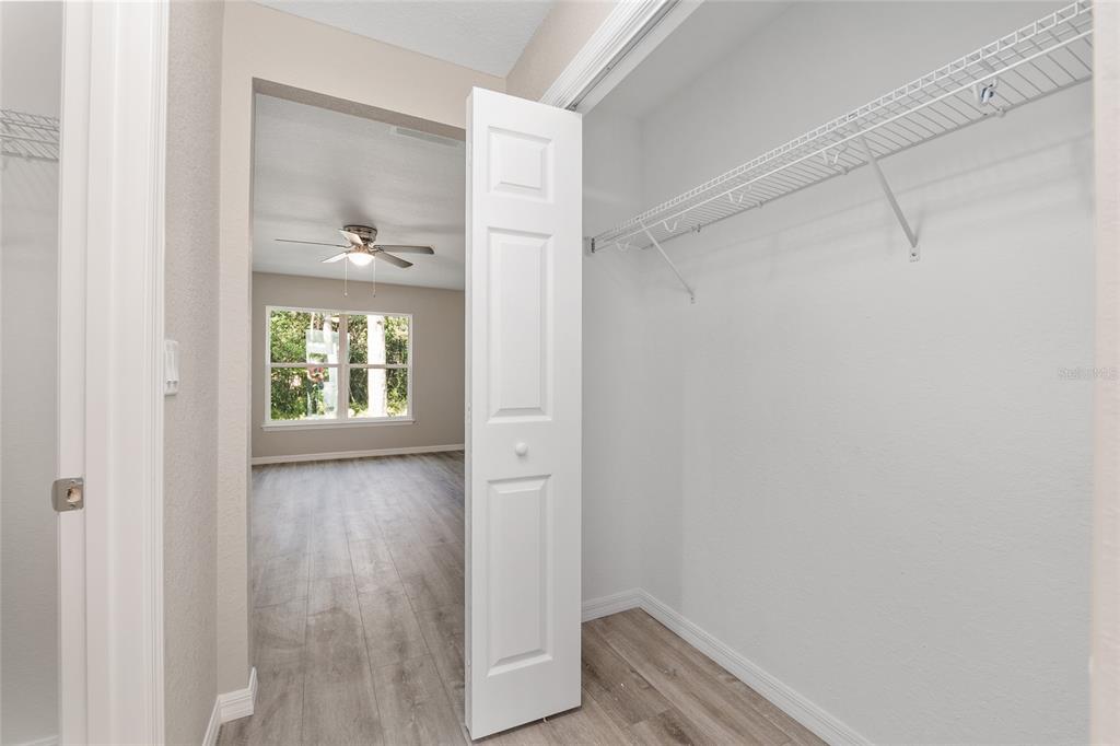 19230 Southwest 97th Street Dunnellon, FL 34432 - Photo 18 of 30 a view of an empty room with wooden floor and a window