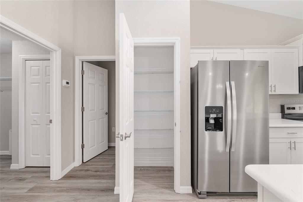 19230 Southwest 97th Street Dunnellon, FL 34432 - Photo 10 of 30 a view of a kitchen with wooden floor and cabinets