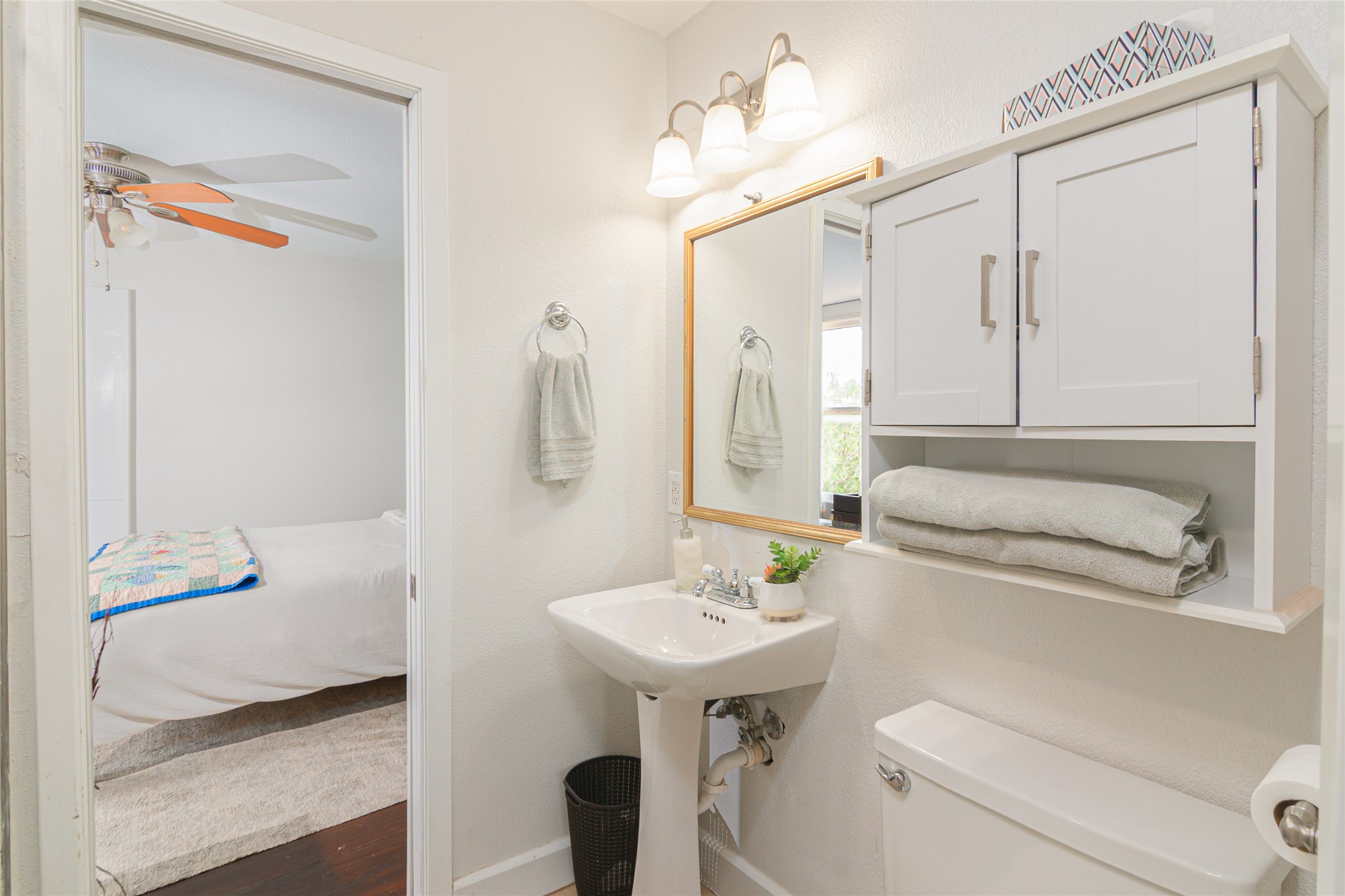 204 Prim Rose Road Blanco, TX 78606 - Photo 25 of 40 Functional layout highlights a pedestal sink and classic built-in storage in this bathroom.