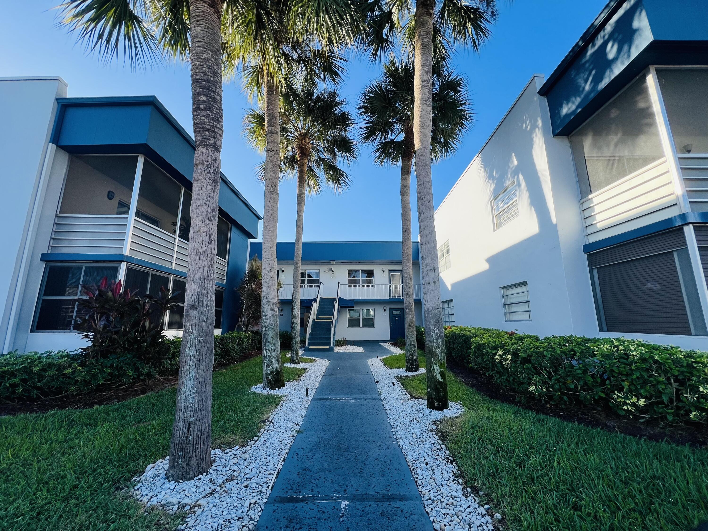 a front view of a house with a garden and patio